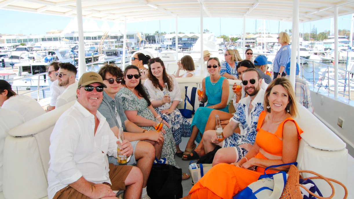 Group enjoying drinks on a luxury yacht during a Gold Coast whale watching tour.
