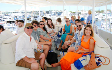 Group enjoying drinks on a luxury yacht during a Gold Coast whale watching tour.
