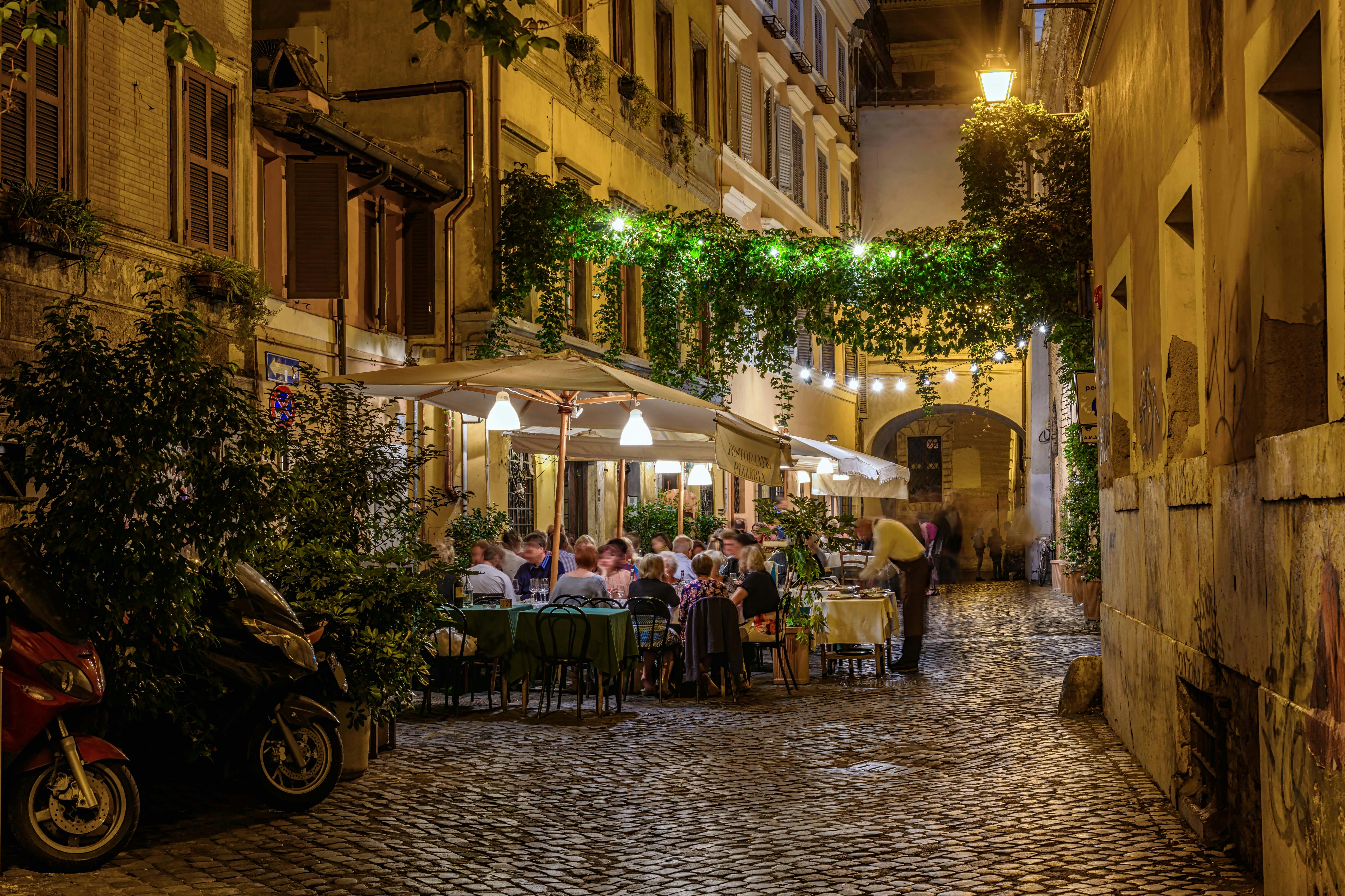 Locals enjoying vibrant nightlife in Trastevere, Rome.