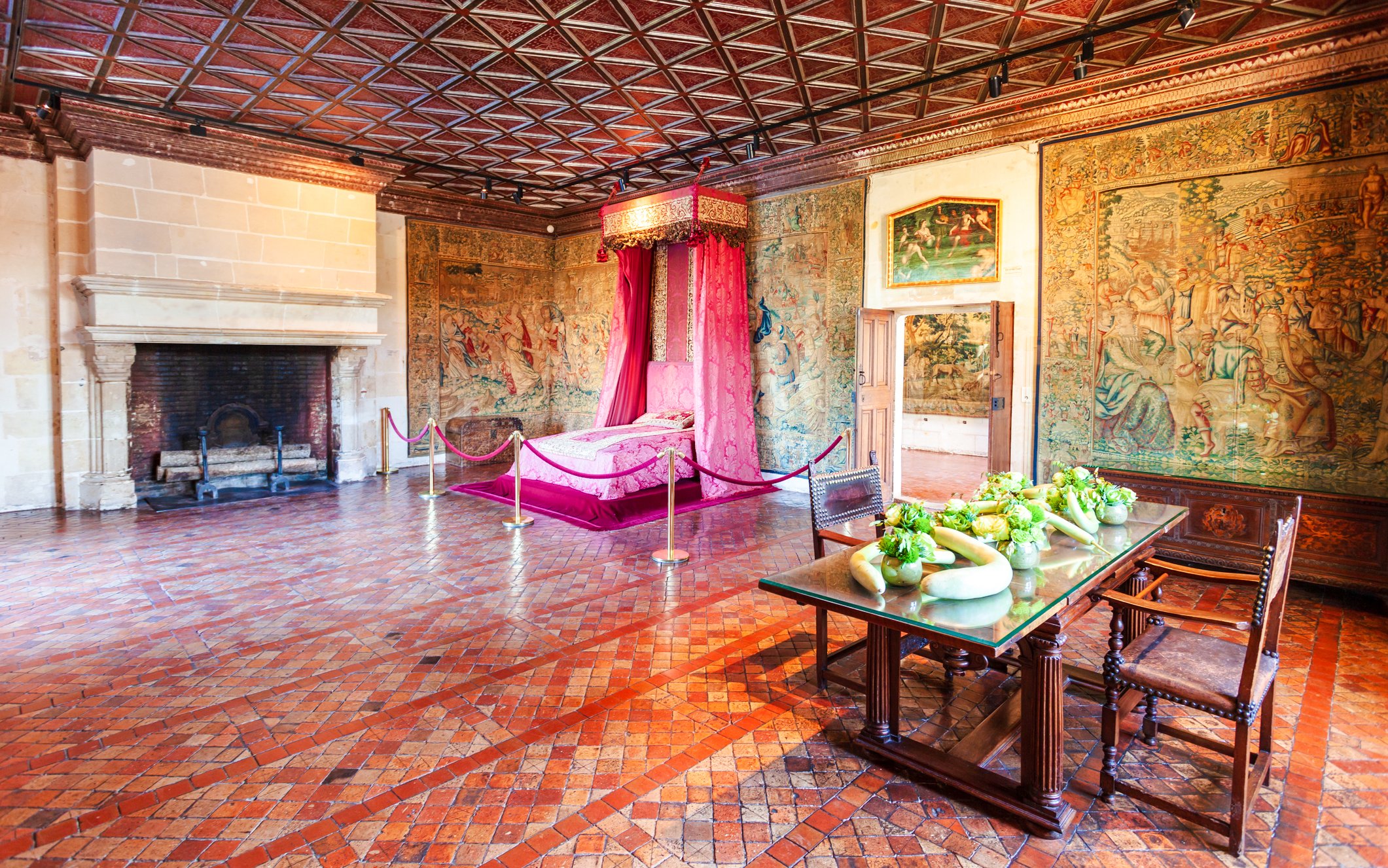 Château de Chenonceau interior with ornate tapestries and a canopy bed, Loire Valley, France.