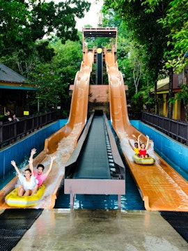 Sunway Lagoon water slide with people descending in Malaysia.