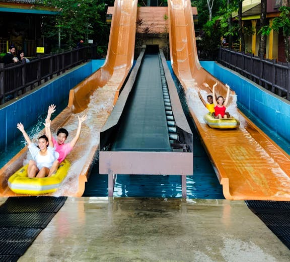 Sunway Lagoon water slide with people descending in Malaysia.