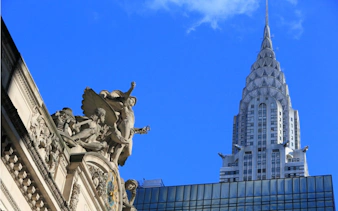 Grand Central Terminal statues with Chrysler Building in New York City.