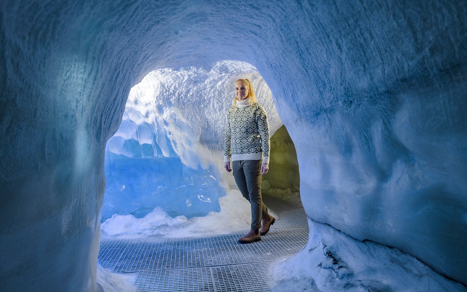 Guests walking through an ice cave exhibit at Perlan Museum in Reykjavik.