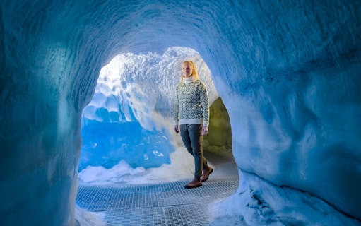 Guests walking through an ice cave exhibit at Perlan Museum in Reykjavik.