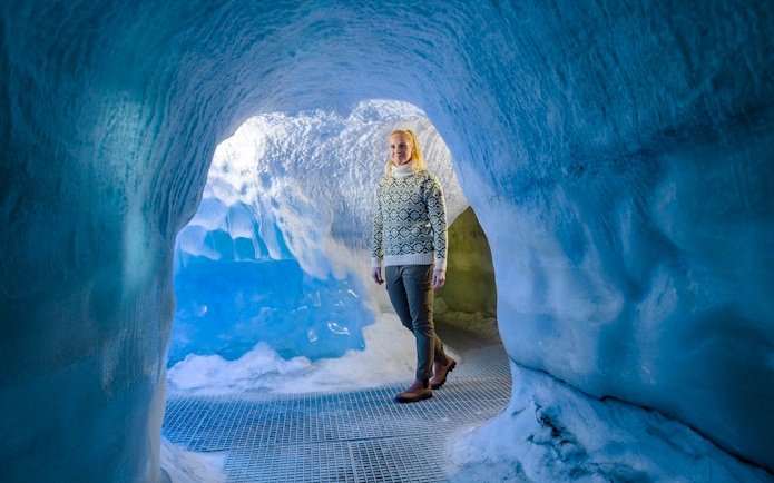 Guests walking through an ice cave exhibit at Perlan Museum in Reykjavik.