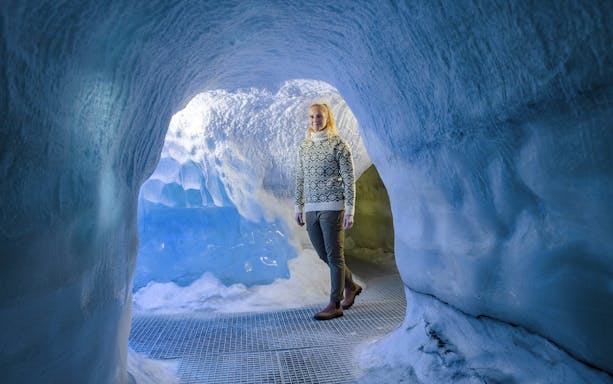 Guests walking through an ice cave exhibit at Perlan Museum in Reykjavik.