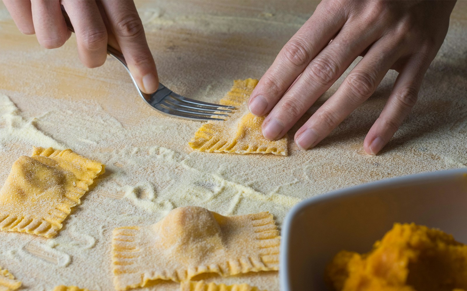Tortelli di Zucca on a plate during a food tour in Milan.