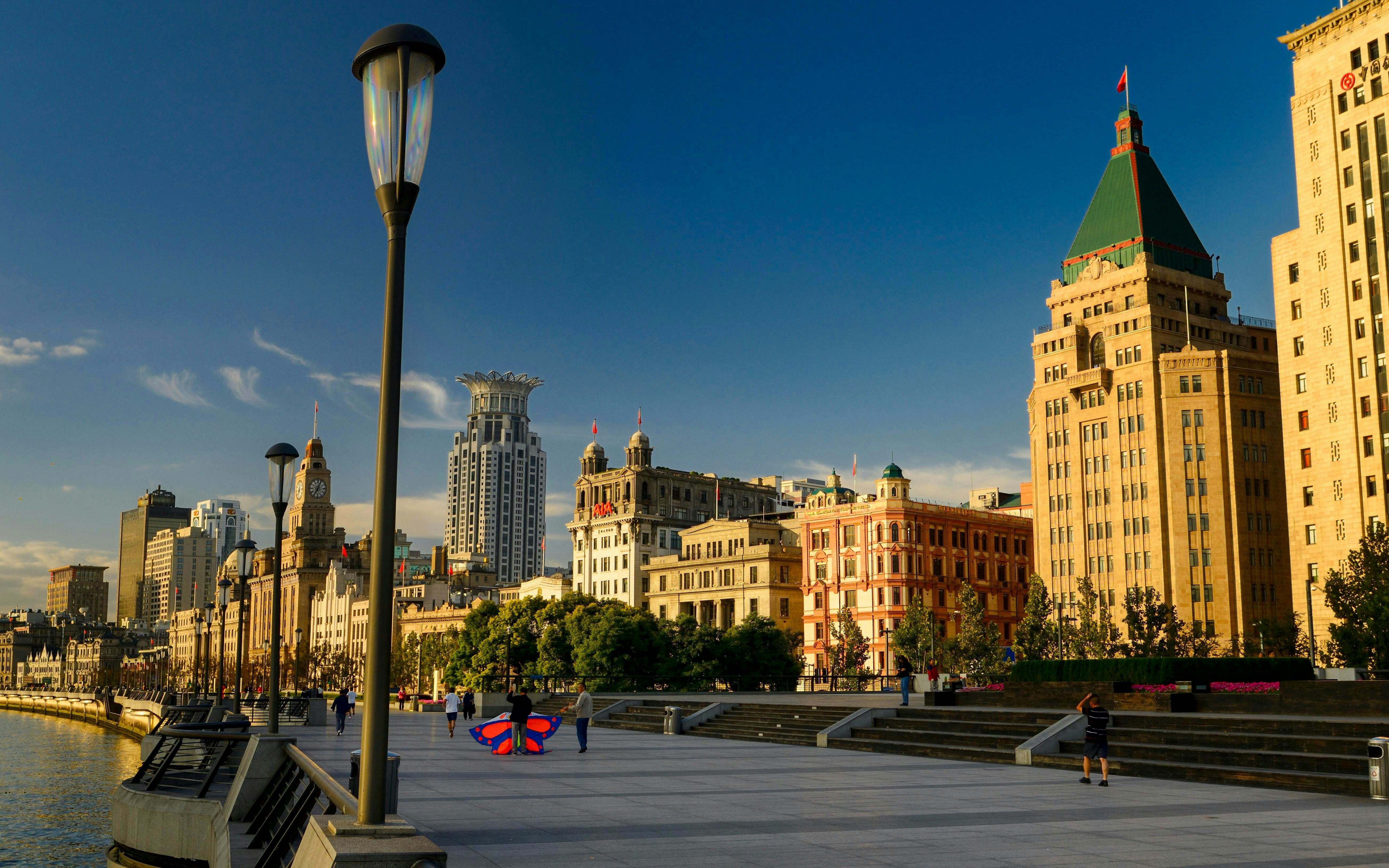 Peace Hotel and Huangpu River promenade in Shanghai, China.
