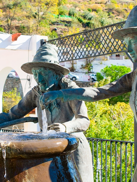 Statues of witches at a fountain in Soportújar, Alpujarra, Granada.