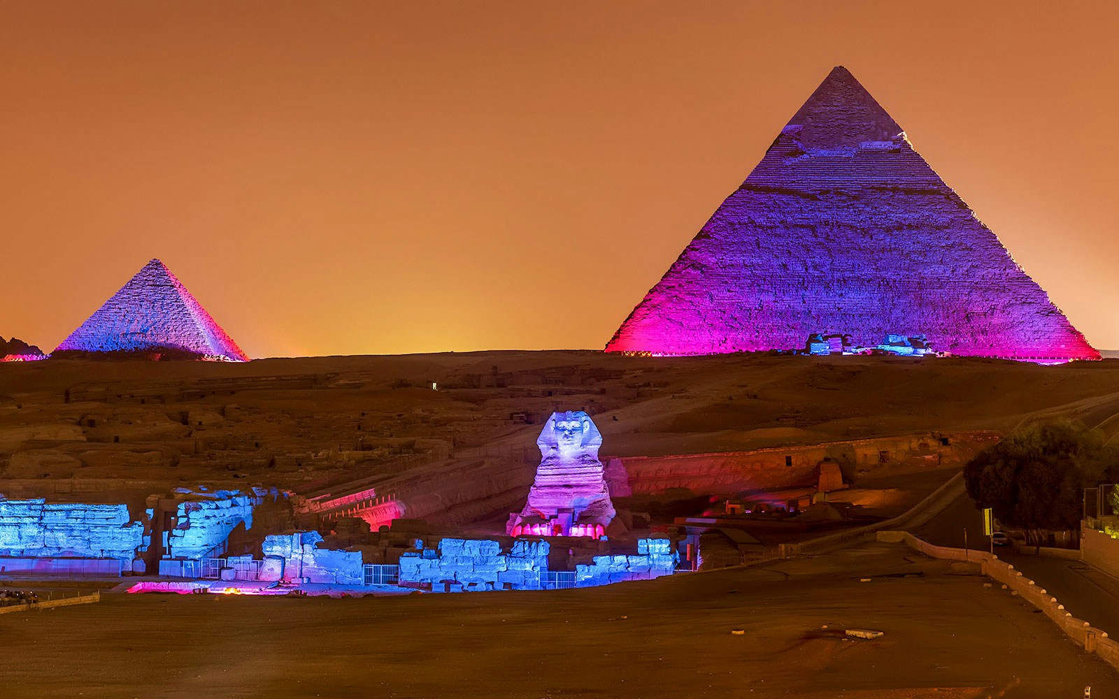 Pyramids and Sphinx illuminated at night, Giza, Egypt.