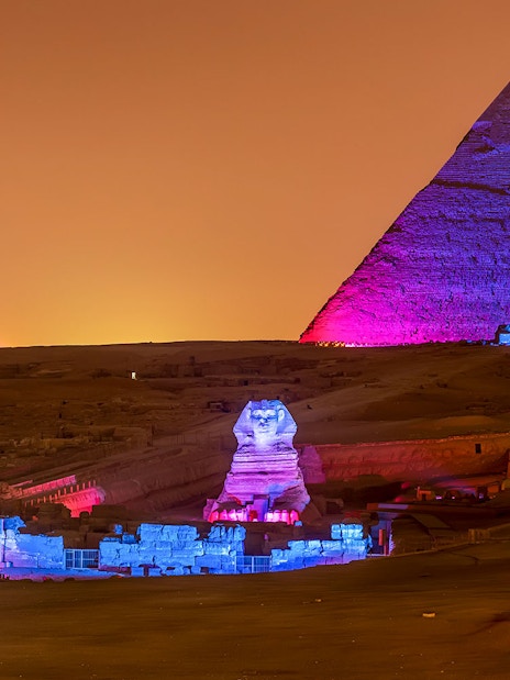 Pyramids and Sphinx illuminated at night, Giza, Egypt.