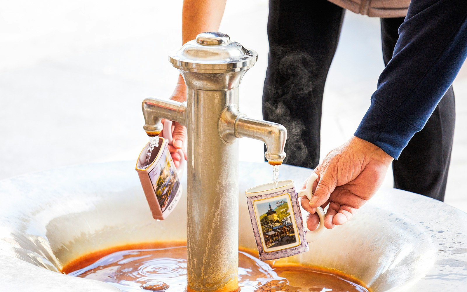 Filling mugs with water from Hot Spring Vřídlo in Karlovy Vary.