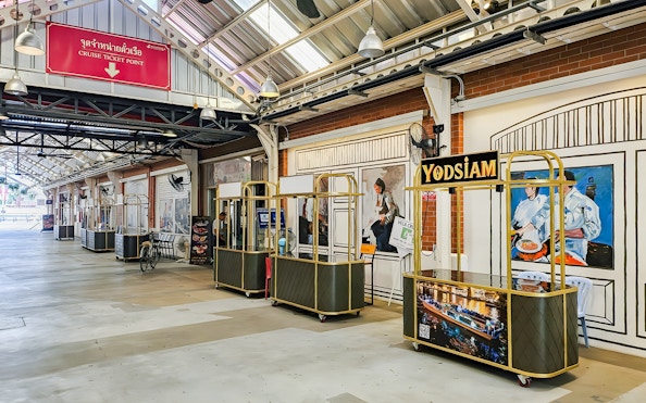 Yodsiam Sightseeing cruise check-in counter at a decorated terminal.
