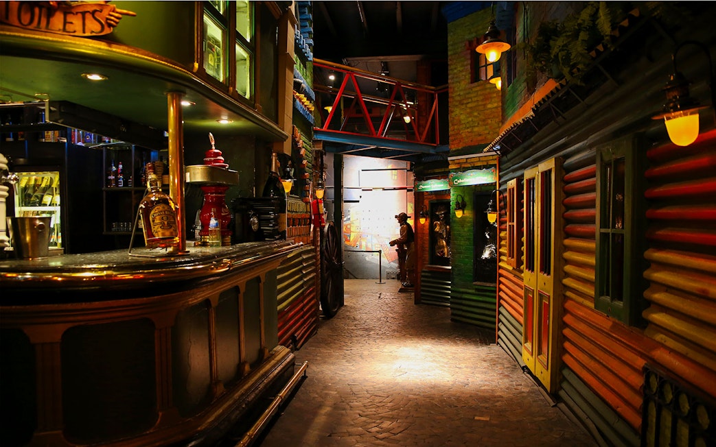 Bar and dining area at Señor Tango Show with colorful decor and dim lighting.