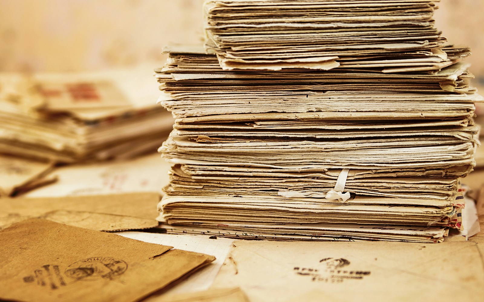 Historic documents displayed in a dimly lit archive room in Paris, France.