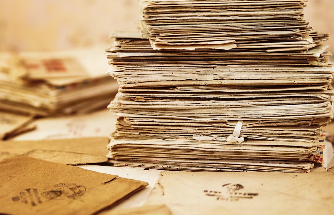 Stack of vintage documents and letters.