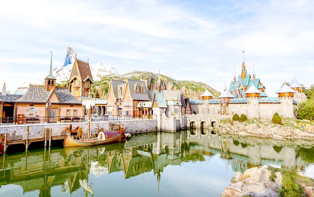 Arendelle village and castle at Disneyland World of Frozen with mountain backdrop.