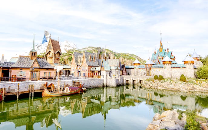 Arendelle village and castle at Disneyland World of Frozen with mountain backdrop.