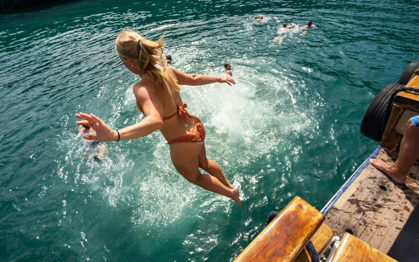 Santorini volcanic islands cruise with view of Palea Kameni hot springs and Thirassia.
