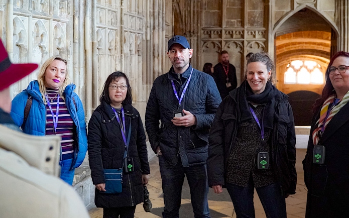 Visitors with guide and audio devices inside Windsor Castle.