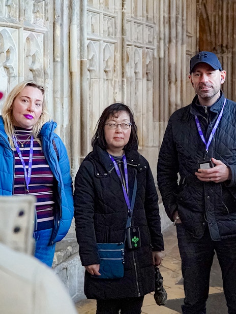 Visitors with guide and audio devices inside Windsor Castle.