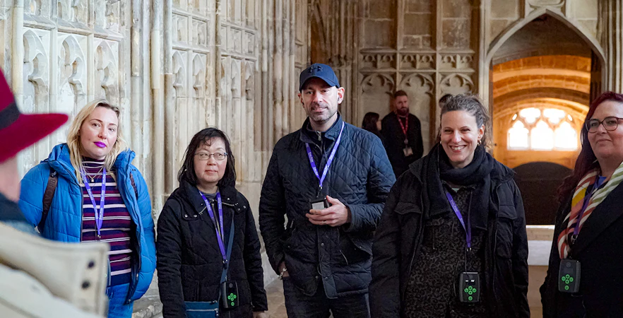 Visitors with guide and audio devices inside Windsor Castle.