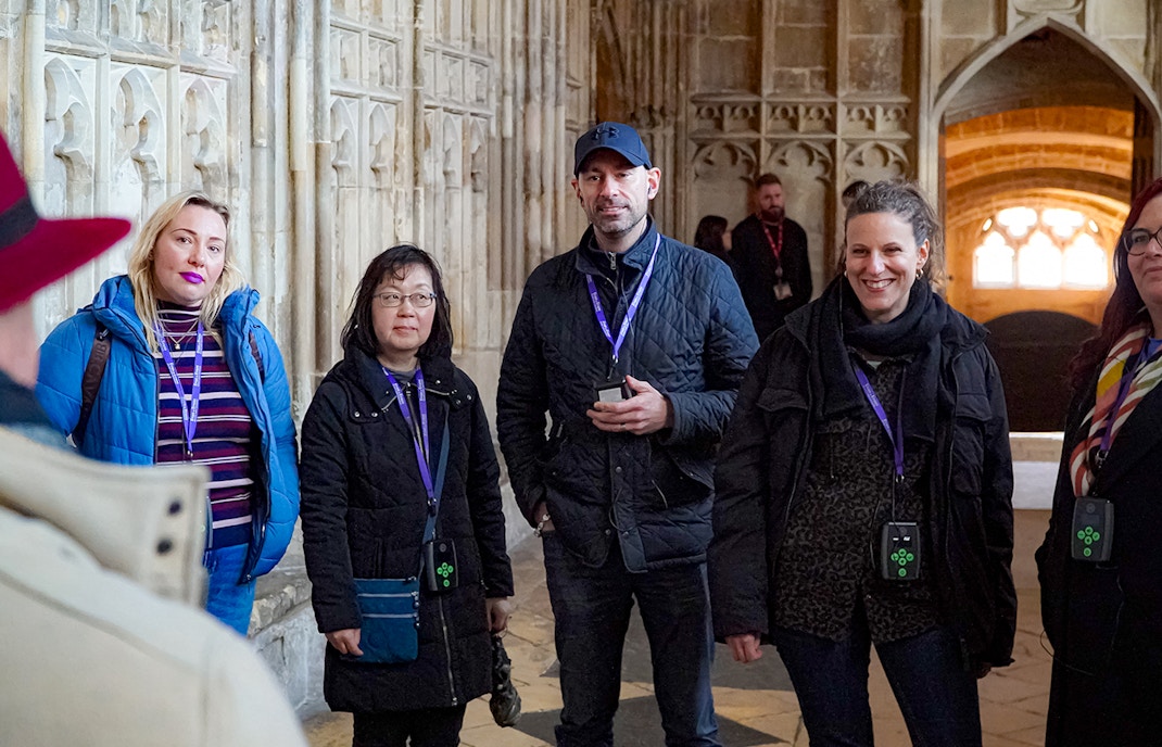 Visitors with guide and audio devices inside Windsor Castle.