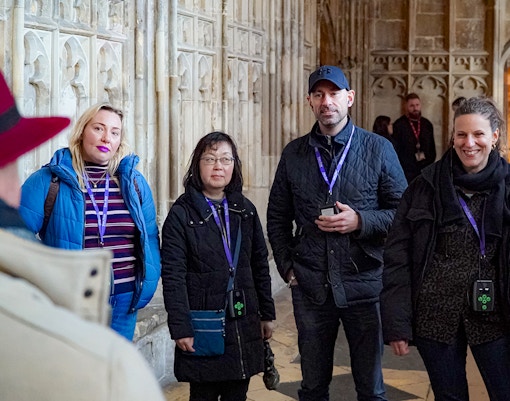 Visitors with guide and audio devices inside Windsor Castle.