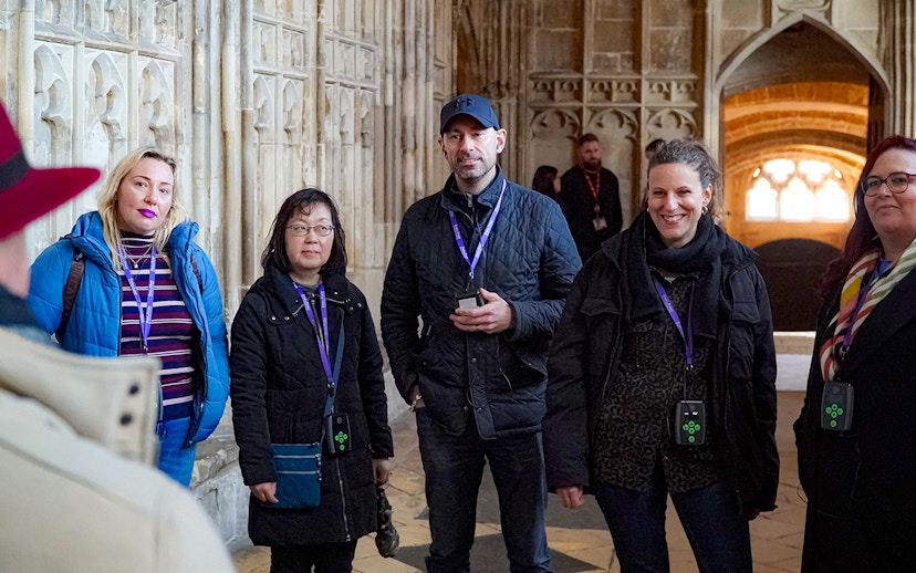 Visitors with guide and audio devices inside Windsor Castle.