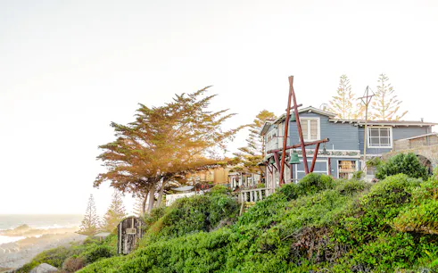 Coastal house surrounded by greenery in Isla Negra, part of the Santiago day tour.