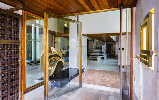 Interior view of Negozio Olivetti in Venice with modern sculpture and staircase.
