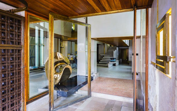 Interior view of Negozio Olivetti in Venice with modern sculpture and staircase.