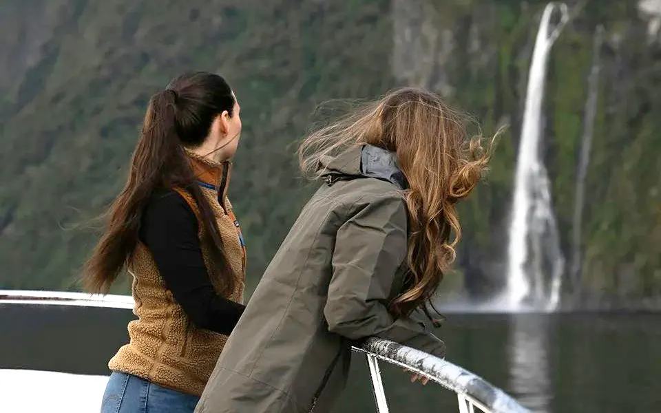 Women viewing waterfall on Milford Sound cruise, Queenstown tour.