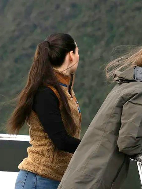 Women viewing waterfall on Milford Sound cruise, Queenstown tour.