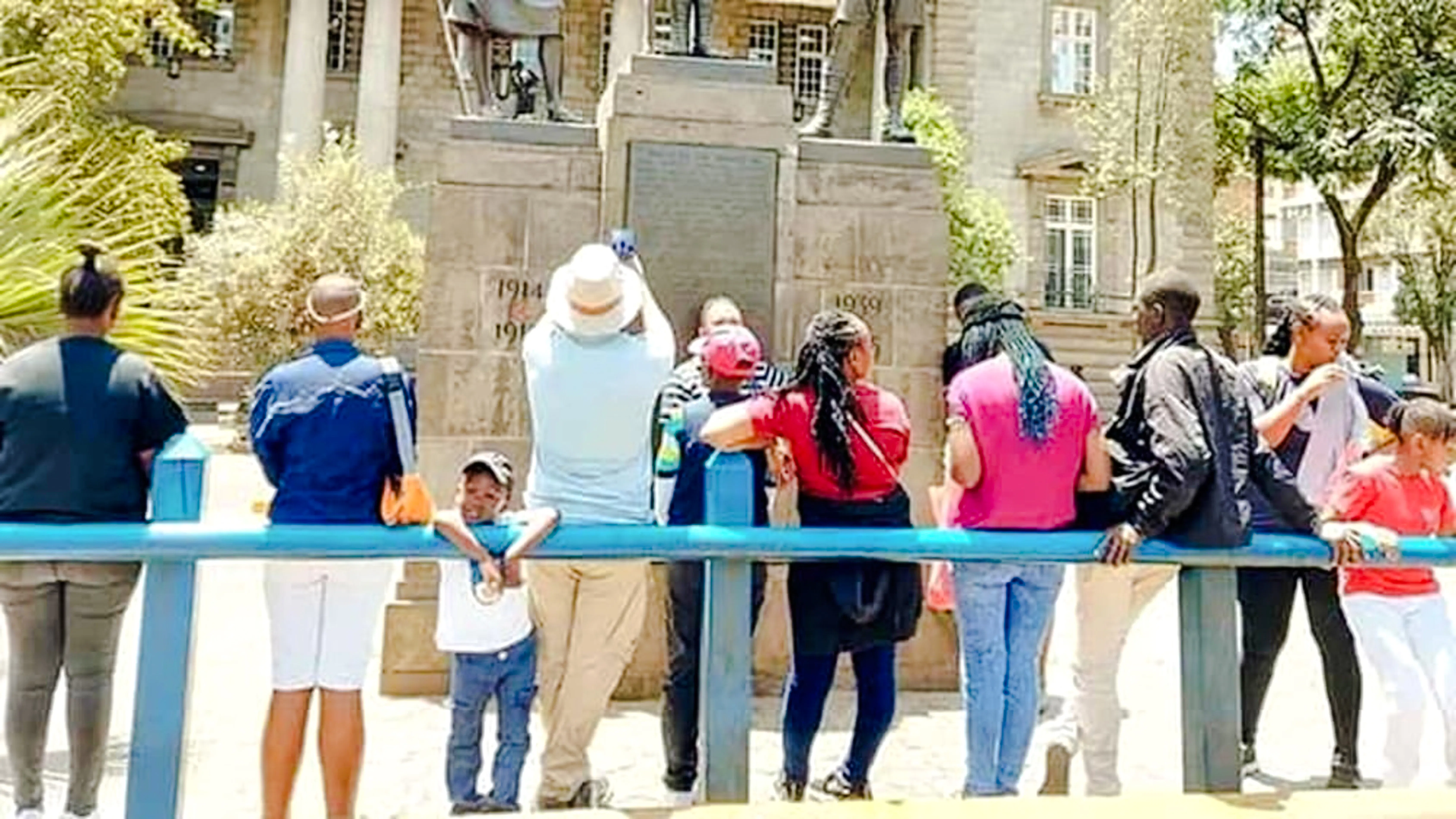 Group of tourists viewing a historical monument in Nairobi during a guided walking tour.