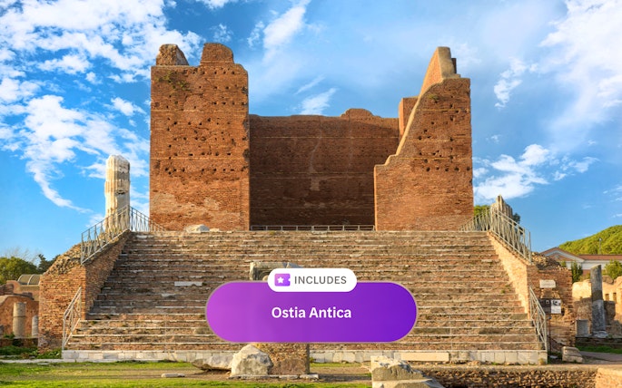 Ancient Roman theater ruins at Ostia Antica under a blue sky.