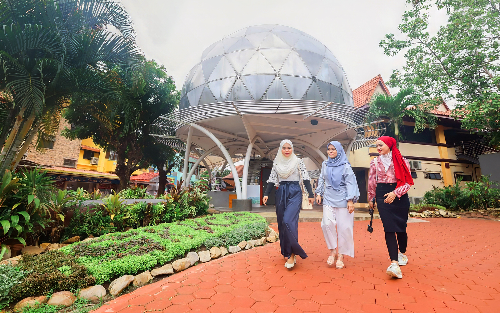 Women walking in front of Skydome Langkawi, Malaysia.