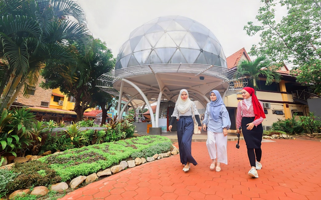 Women walking in front of Skydome Langkawi, Malaysia.
