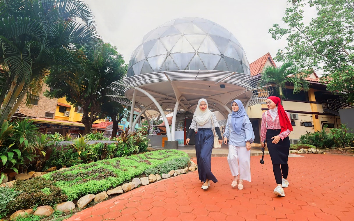Women walking in front of Skydome Langkawi, Malaysia.