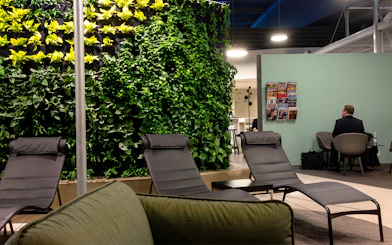 Lounge chairs and vertical garden at Pearl Lounge, Stockholm Arlanda Airport Terminal 2.