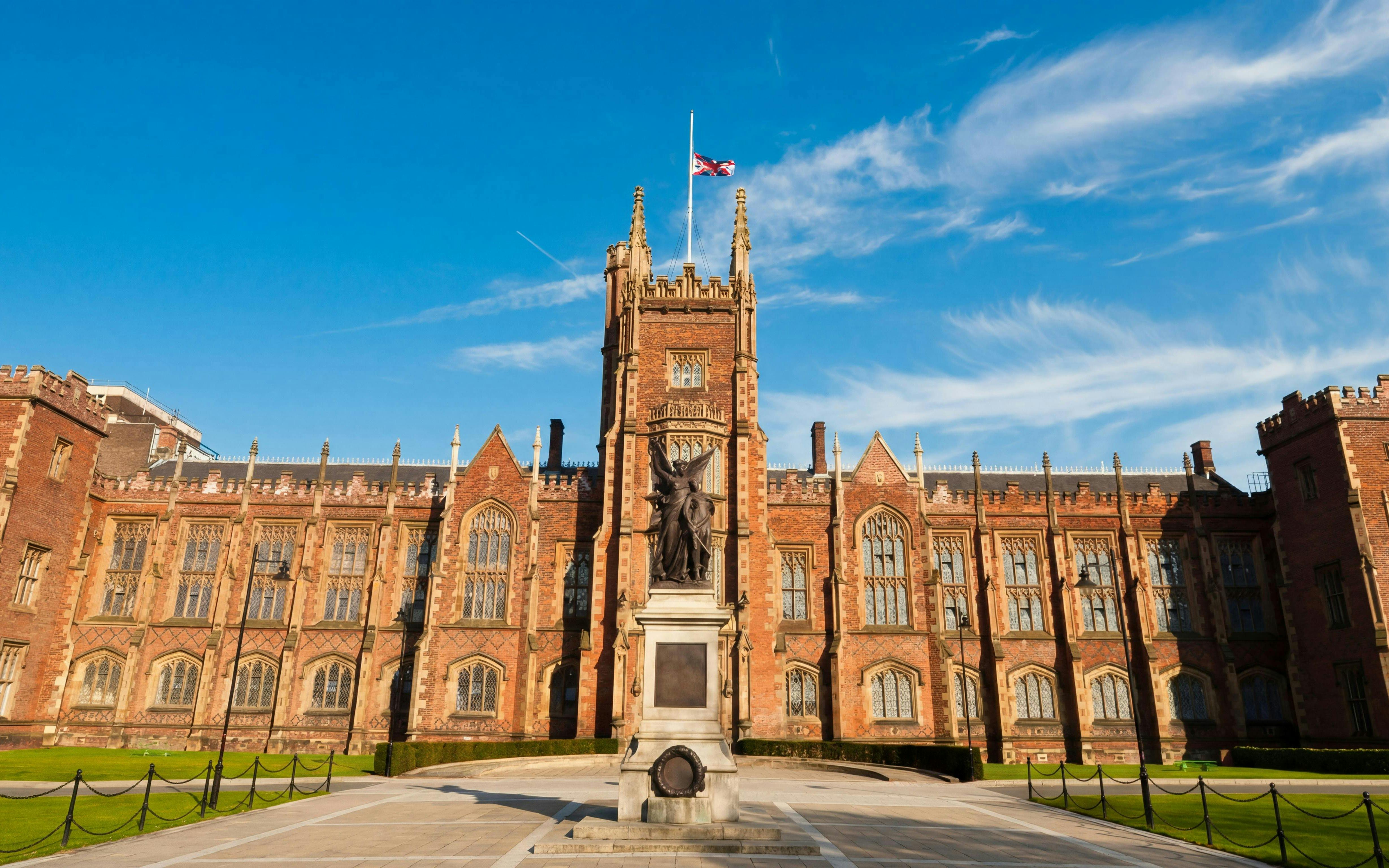 Queen's University Belfast main building with statue in front.