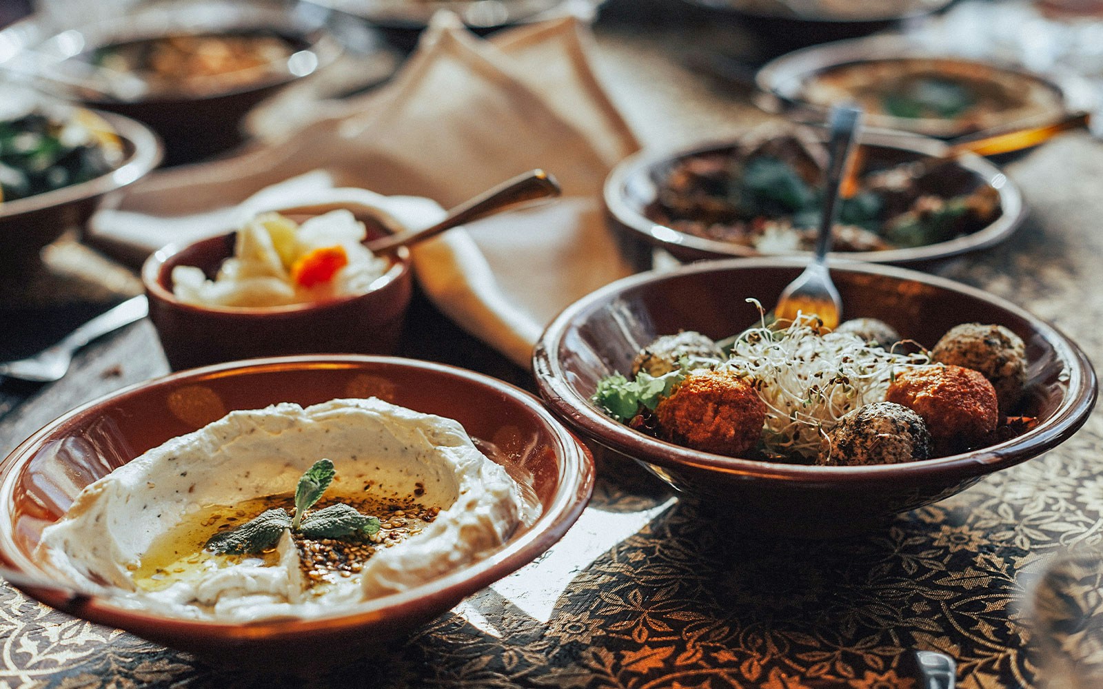 Arabic buffet spread with traditional dishes and desserts in Dubai.