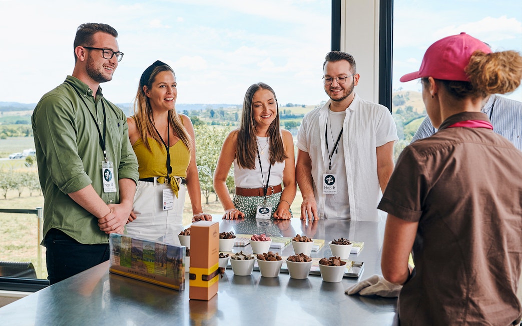 Tourists at Yarra Valley winery learning about chocolate made with alcohol.