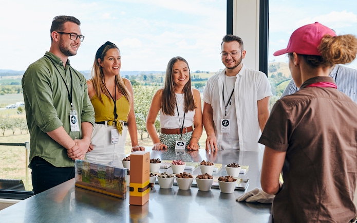 Tourists at Yarra Valley winery learning about chocolate made with alcohol.
