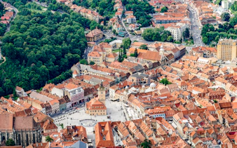 Aerial view of Brasov city center with Council Square and surrounding buildings, Romania.