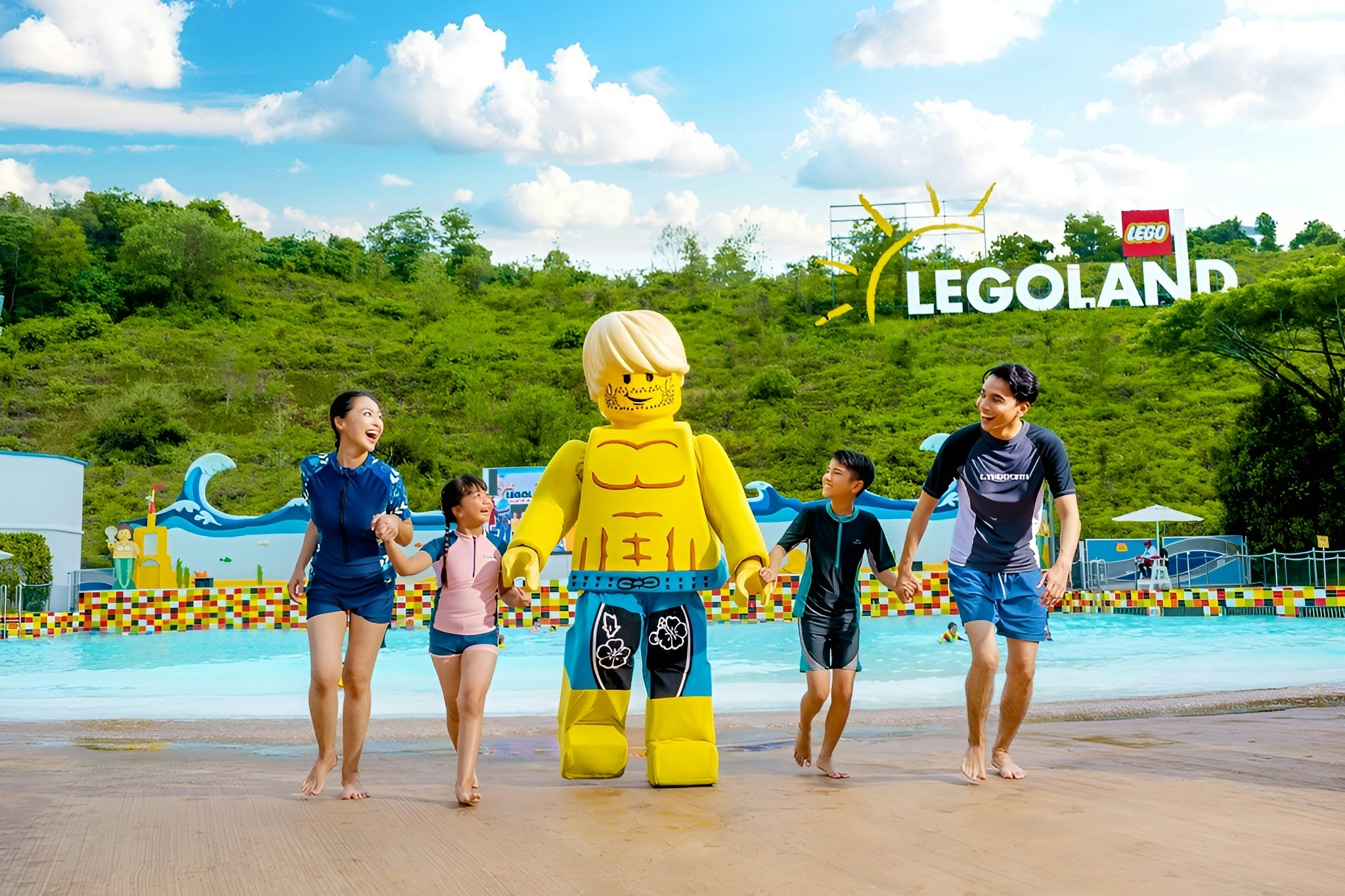 Family enjoying Legoland Water Park with Lego figure.