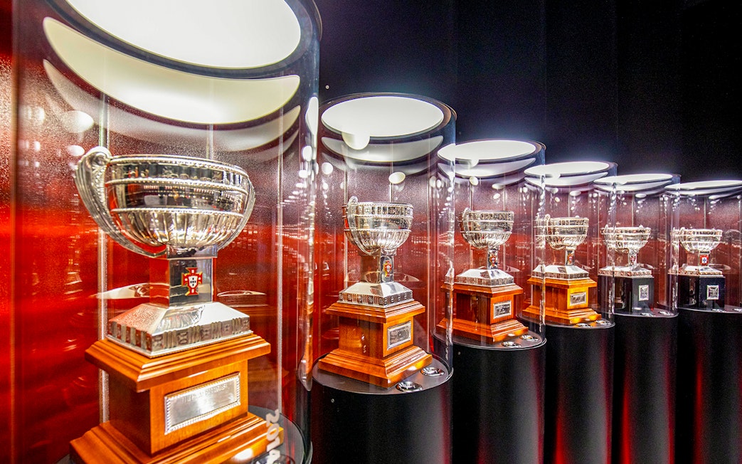 Benfica Stadium museum display of silver trophies in glass cases.
