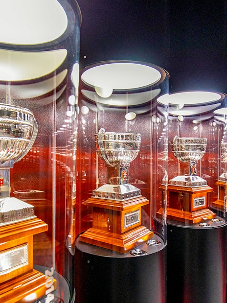 Benfica Stadium museum display of silver trophies in glass cases.