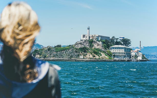 Visitor viewing Alcatraz Island from a boat on San Francisco Bay.